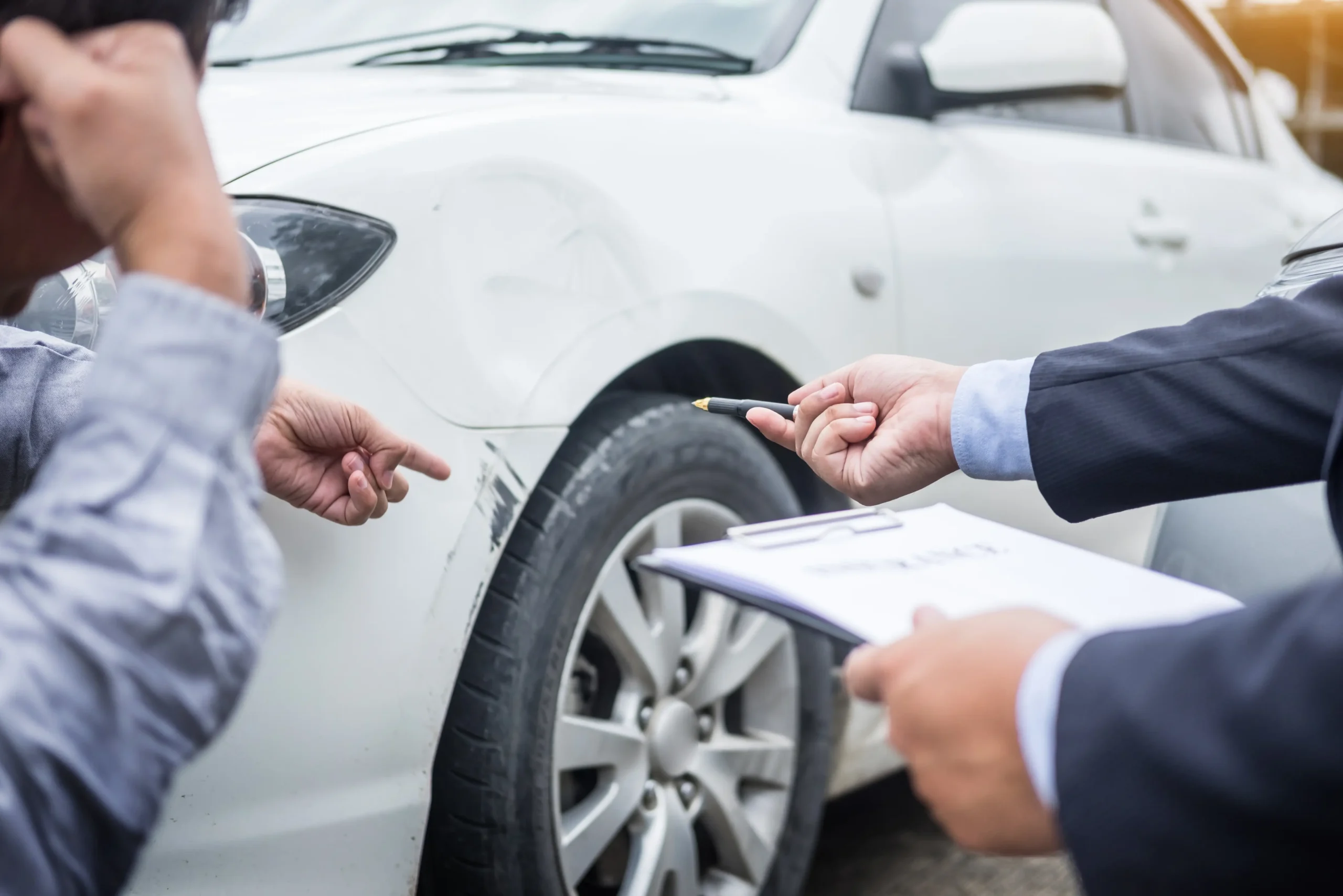 Insurance adjuster documenting vehicle damage after a car accident in Auburn, CA